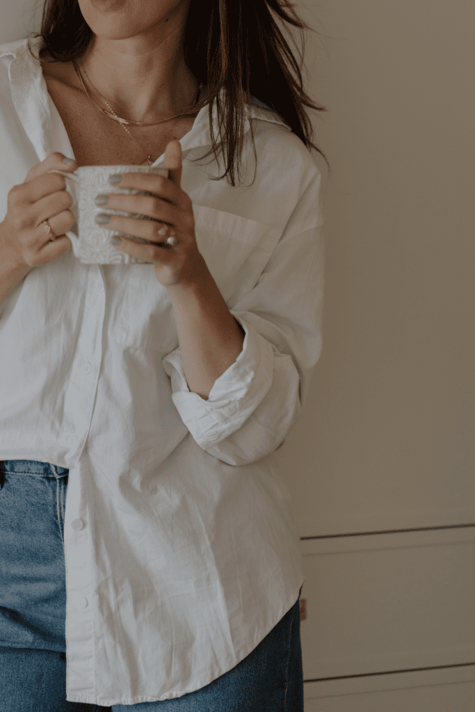 Woman holding white mug